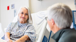 Senior woman in hospital bed with her husband