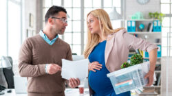 Pregnant woman being fired from job by employer