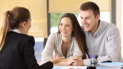 Couple talking with a real estate agent