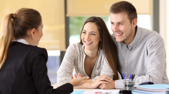Couple talking with a real estate agent