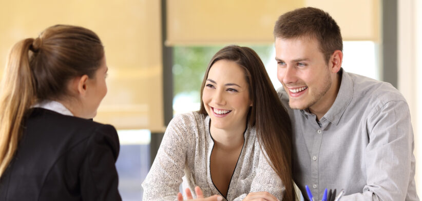 Couple talking with a real estate agent